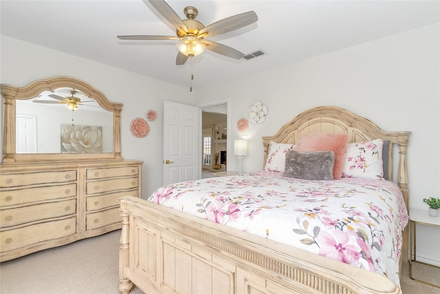 bedroom featuring light carpet, ceiling fan, and visible vents