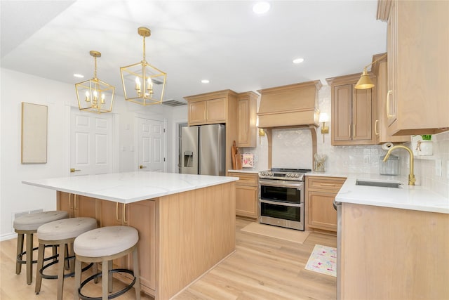 kitchen featuring a center island, stainless steel appliances, a sink, light wood-type flooring, and premium range hood