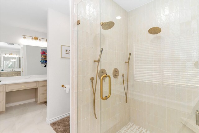 bathroom with vanity, baseboards, and walk in shower