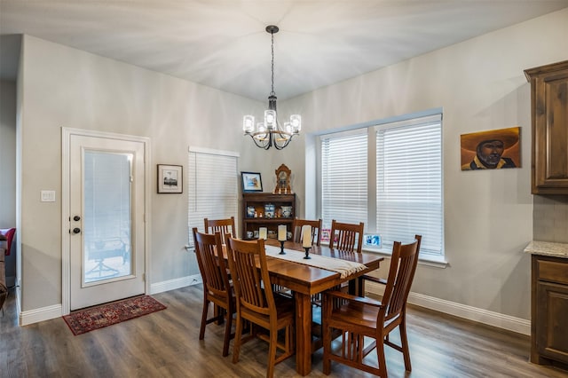 dining room featuring baseboards, dark wood finished floors, and a notable chandelier