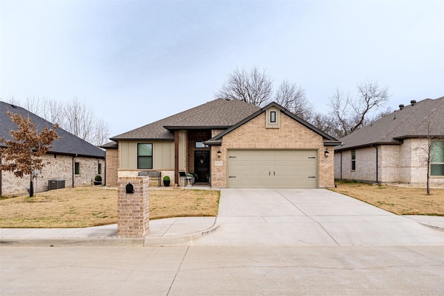 view of front of house with a garage, concrete driveway, roof with shingles, cooling unit, and brick siding