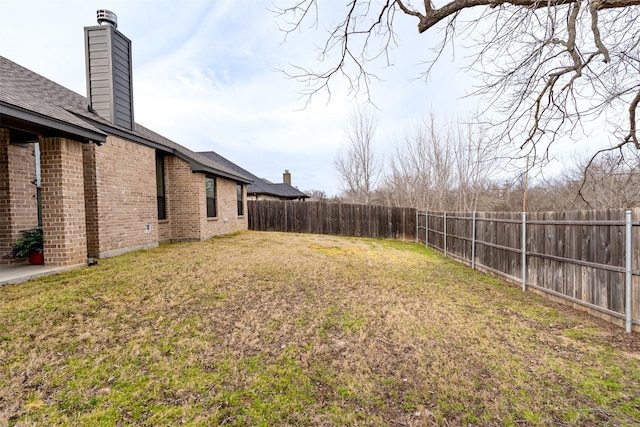 view of yard with a fenced backyard