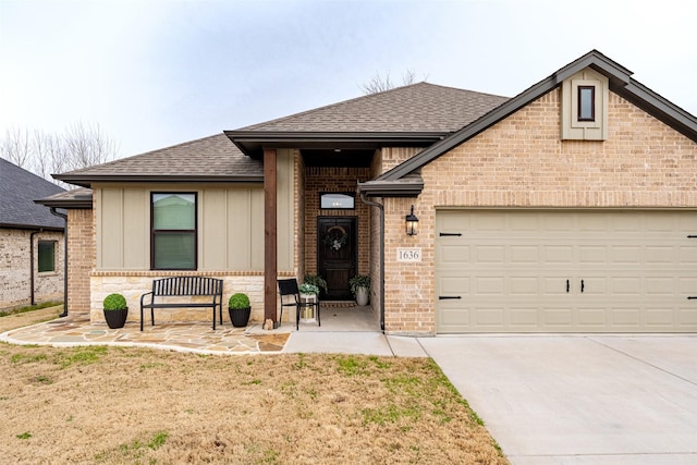 view of front of property with a garage, concrete driveway, a shingled roof, and brick siding