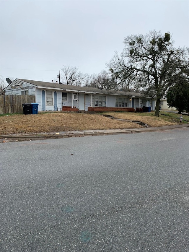 view of front of home featuring fence