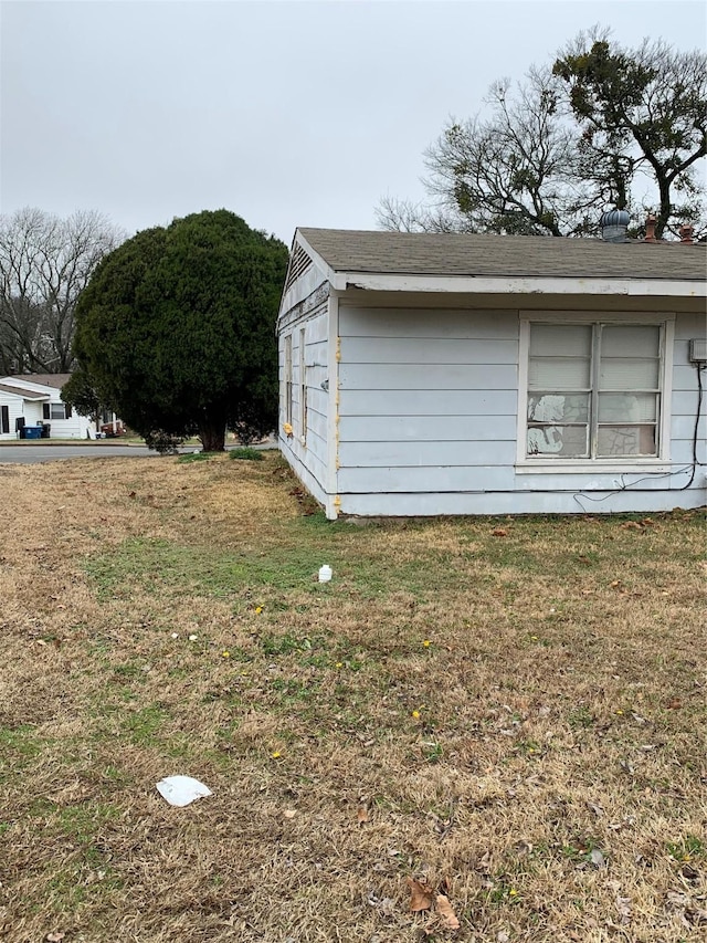 view of side of home with a lawn