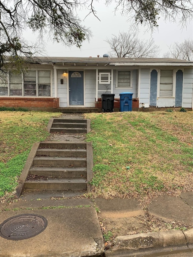 ranch-style home with a front lawn