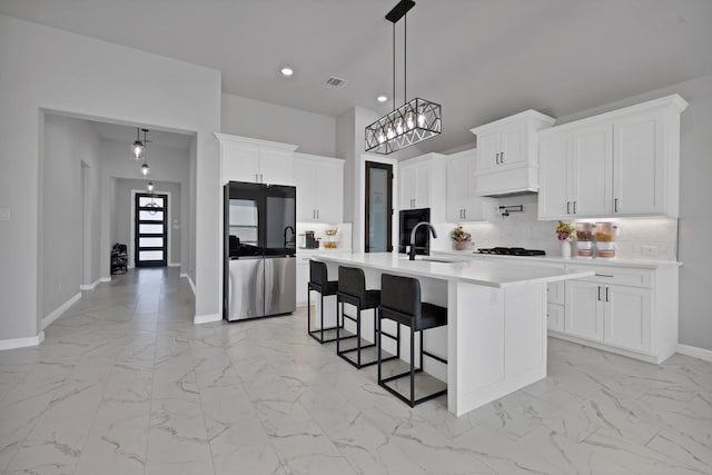 kitchen featuring marble finish floor, smart refrigerator, light countertops, and backsplash