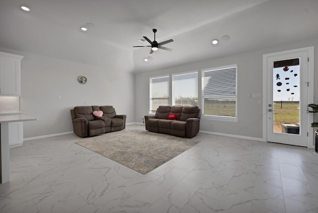 living area with marble finish floor, recessed lighting, and baseboards