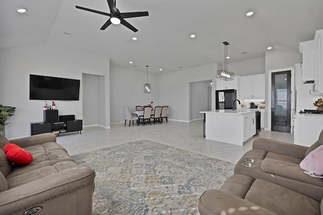 living area featuring vaulted ceiling, marble finish floor, baseboards, and recessed lighting