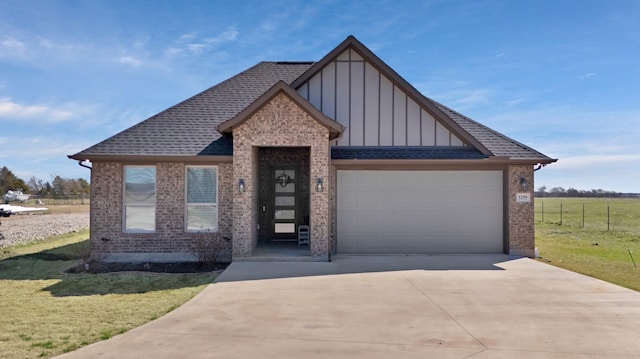 view of front of home with a garage, a shingled roof, concrete driveway, board and batten siding, and a front yard