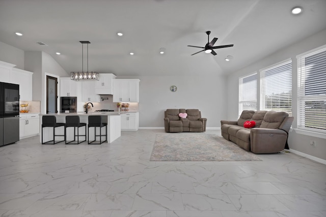 living room featuring marble finish floor, baseboards, and recessed lighting