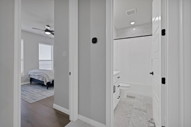 ensuite bathroom with shower / tub combo, marble finish floor, baseboards, and visible vents