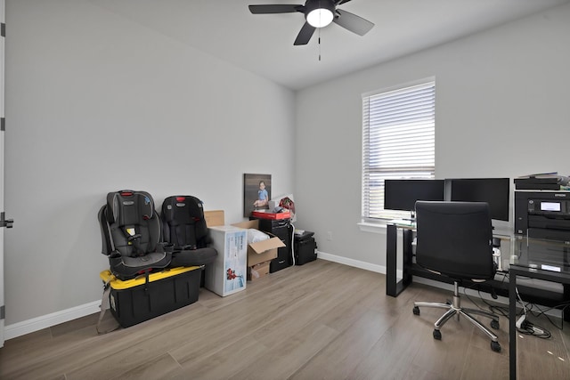 office with a ceiling fan, baseboards, and wood finished floors