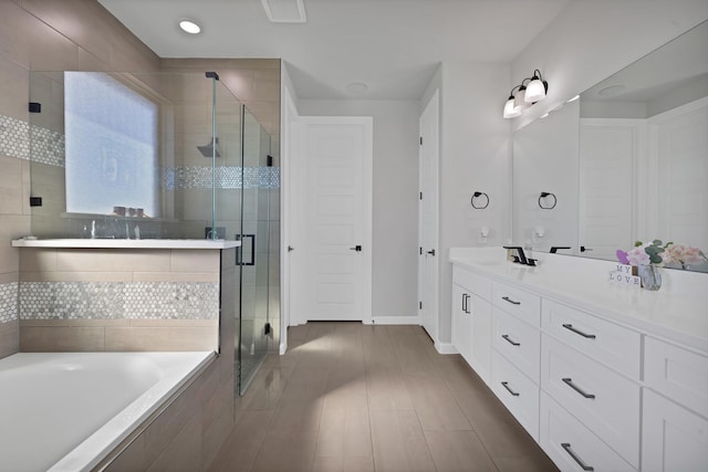 full bathroom featuring a stall shower, baseboards, visible vents, vanity, and a bath