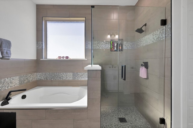 full bathroom featuring a stall shower and a garden tub