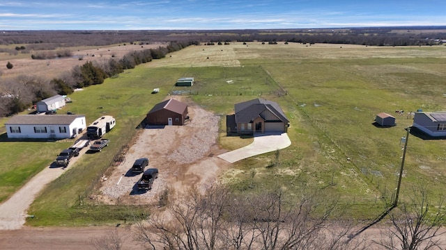 birds eye view of property with a rural view