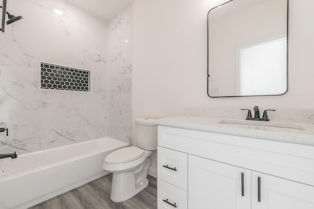 bathroom with vanity, bathing tub / shower combination, wood finished floors, and toilet