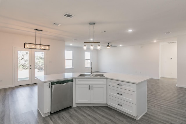 kitchen with light countertops, visible vents, open floor plan, a sink, and dishwasher