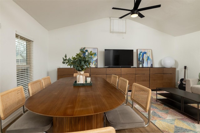 dining area with a ceiling fan and lofted ceiling