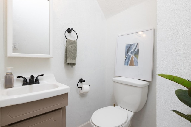 bathroom with toilet and vanity