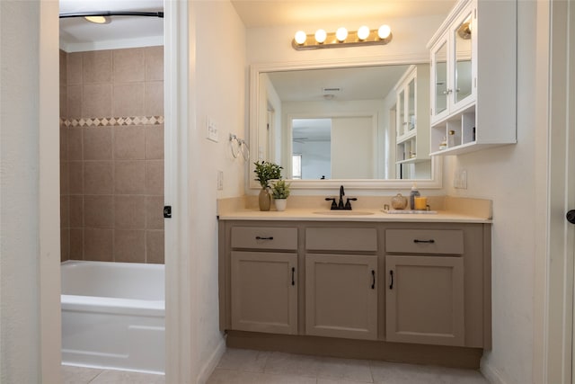 full bathroom with tile patterned flooring, baseboards, shower / bathing tub combination, and vanity