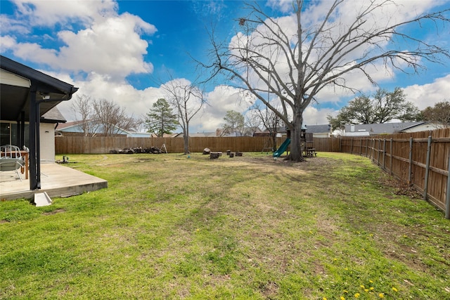 view of yard with a fenced backyard and a playground