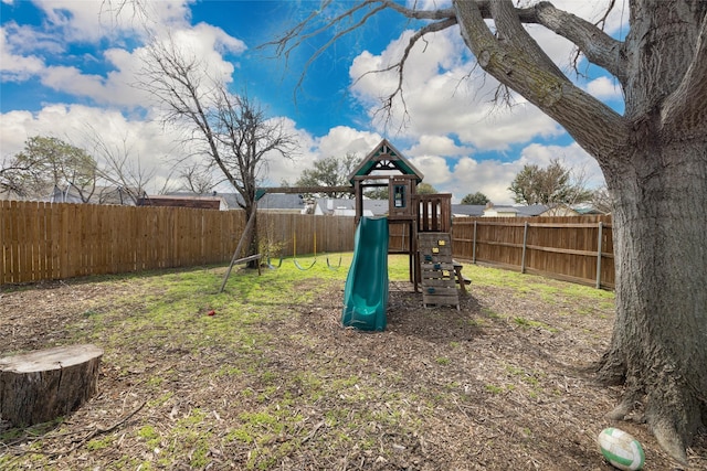 view of yard with a fenced backyard and a playground