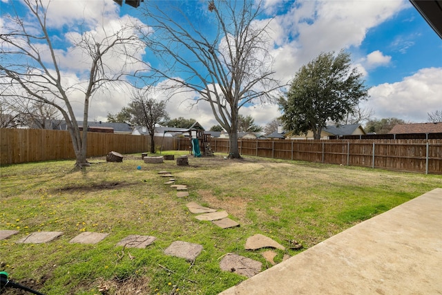 view of yard with a playground and a fenced backyard