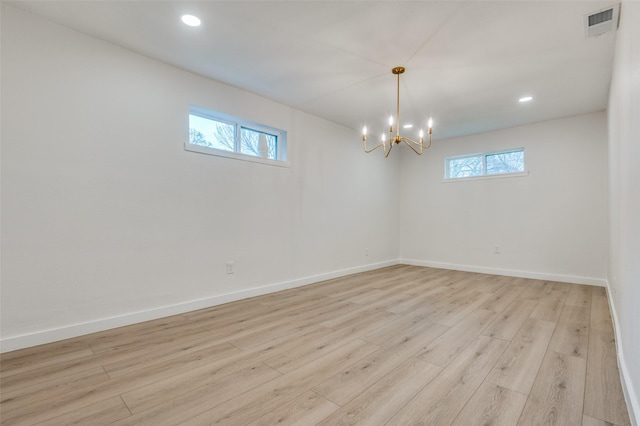 empty room with light wood-style flooring, visible vents, baseboards, and recessed lighting