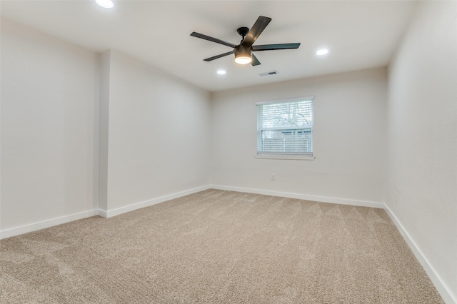 empty room featuring recessed lighting, visible vents, a ceiling fan, light carpet, and baseboards