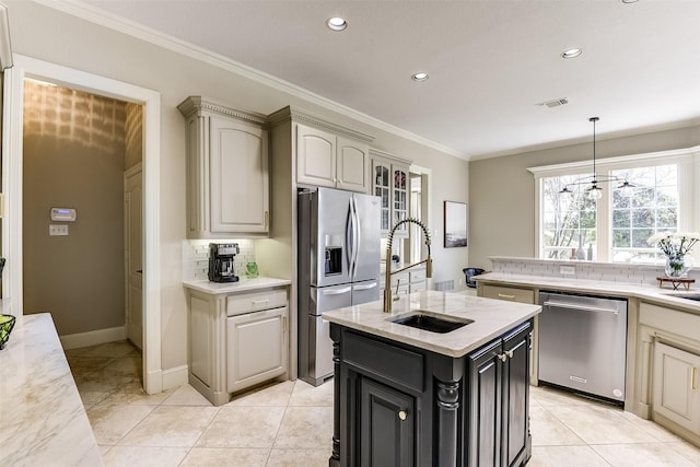 kitchen featuring stainless steel appliances, tasteful backsplash, ornamental molding, a sink, and an island with sink