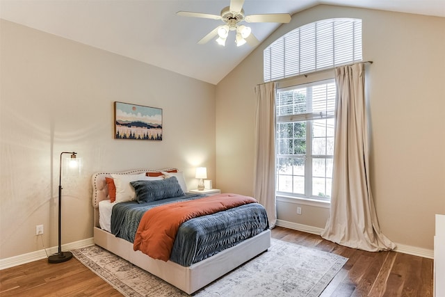 bedroom featuring lofted ceiling, ceiling fan, baseboards, and wood finished floors