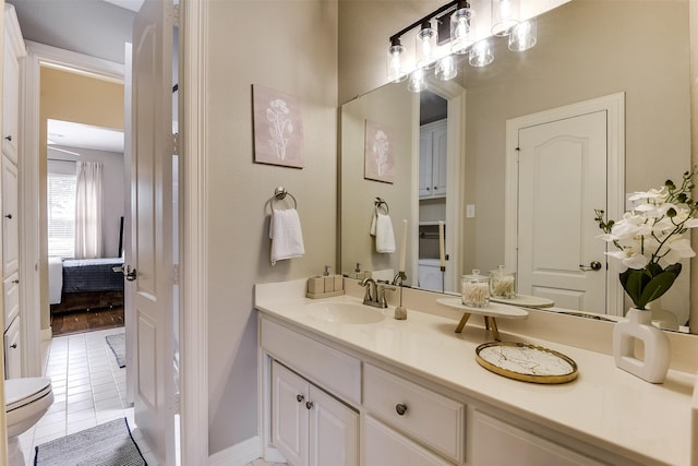 bathroom with ensuite bath, vanity, toilet, and tile patterned floors