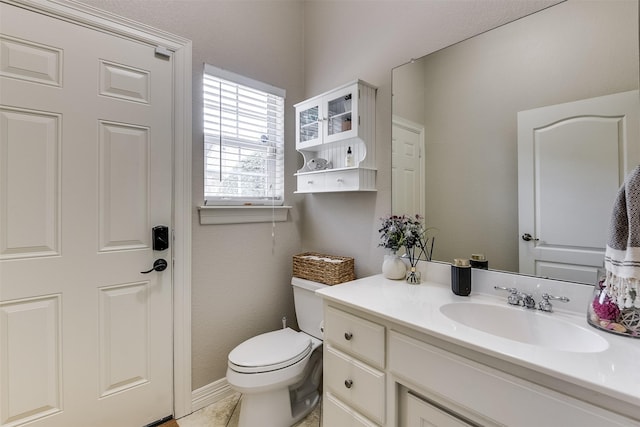 bathroom featuring toilet, tile patterned flooring, and vanity