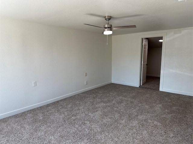 unfurnished bedroom with a ceiling fan, baseboards, dark carpet, and a textured ceiling