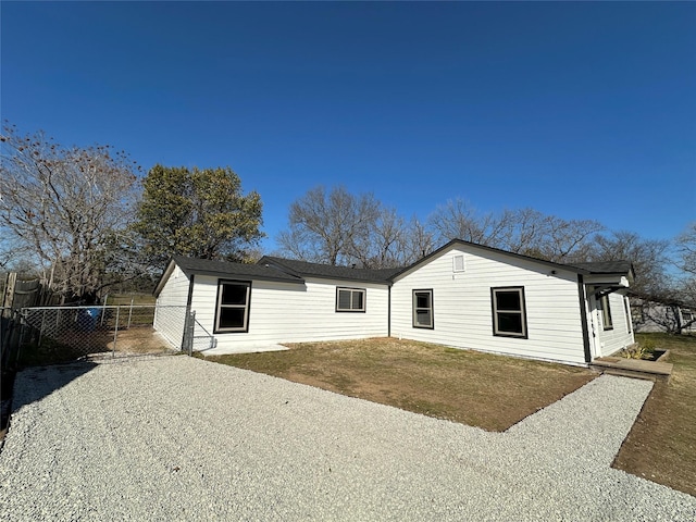 view of front of house featuring a front yard, a gate, and fence