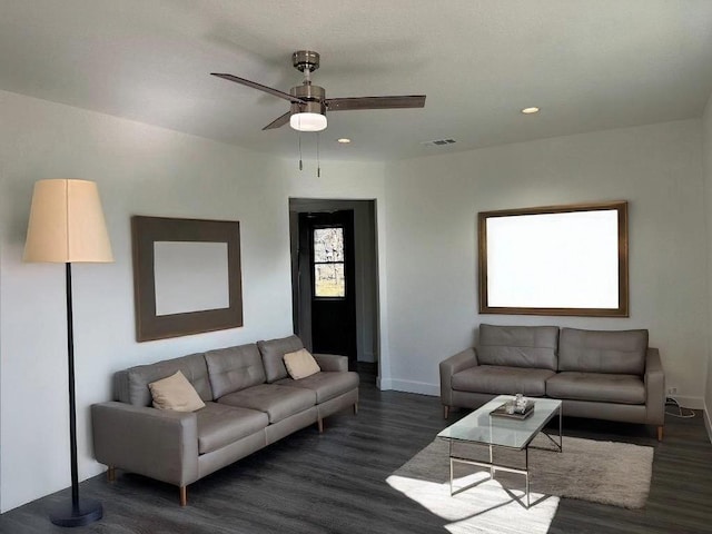 living area with recessed lighting, visible vents, baseboards, and wood finished floors