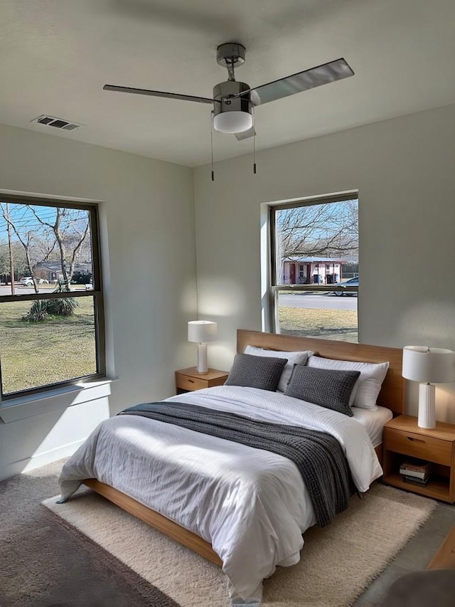 carpeted bedroom featuring visible vents and ceiling fan