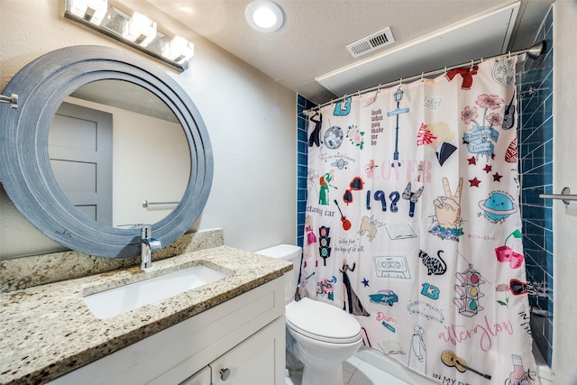 bathroom featuring visible vents, toilet, curtained shower, a textured ceiling, and vanity