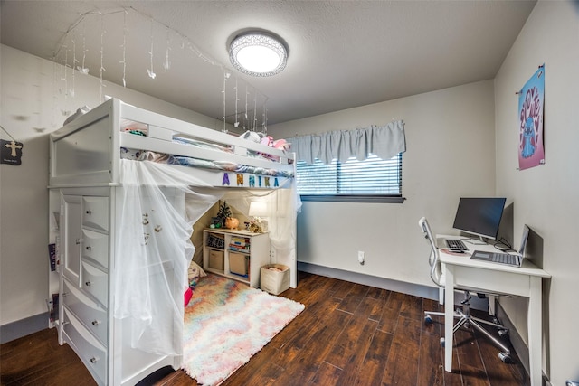 bedroom with hardwood / wood-style floors and baseboards