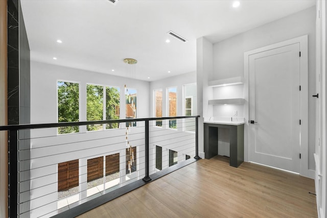 corridor featuring recessed lighting, visible vents, and wood finished floors