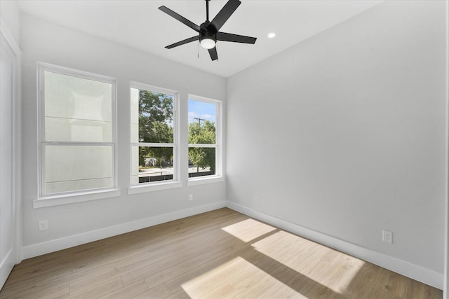 unfurnished room with a ceiling fan, baseboards, wood finished floors, and recessed lighting