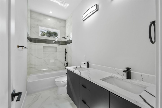 full bathroom with washtub / shower combination, marble finish floor, a sink, and toilet