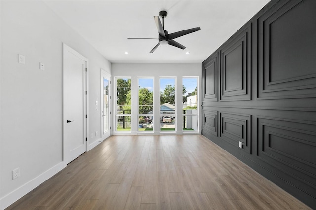 unfurnished living room featuring light wood-type flooring, baseboards, a ceiling fan, and recessed lighting