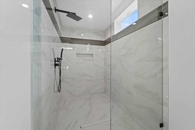 full bathroom featuring recessed lighting and a marble finish shower