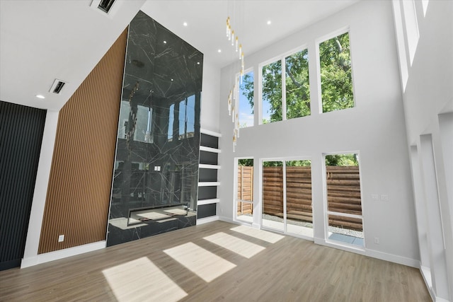 unfurnished living room with recessed lighting, visible vents, and wood finished floors