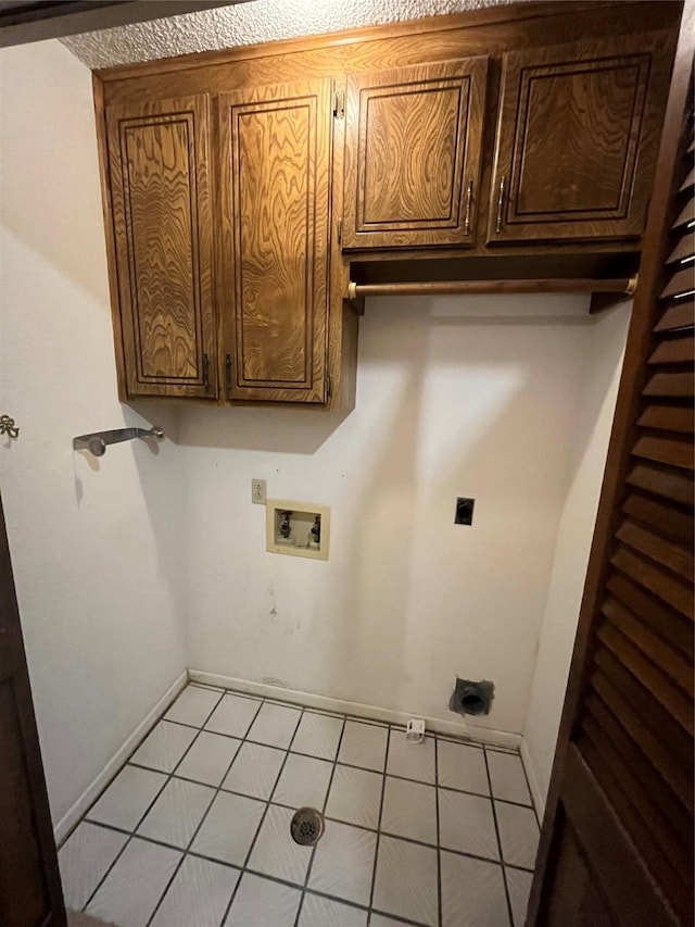 laundry area with baseboards, washer hookup, light tile patterned floors, cabinet space, and hookup for an electric dryer