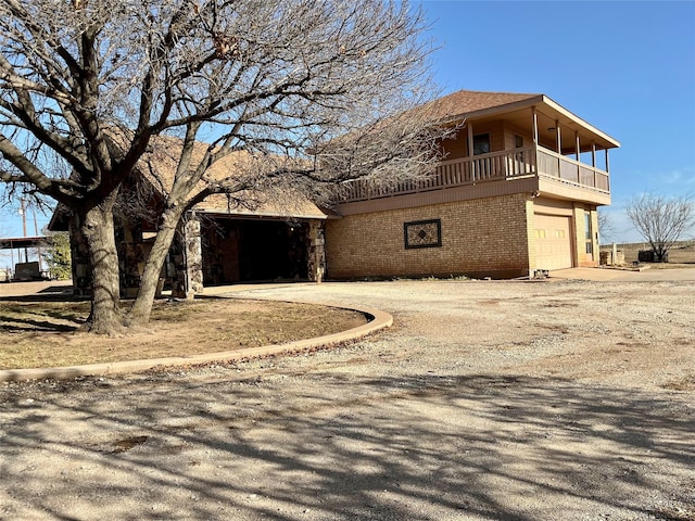 view of property featuring brick siding, concrete driveway, and a garage