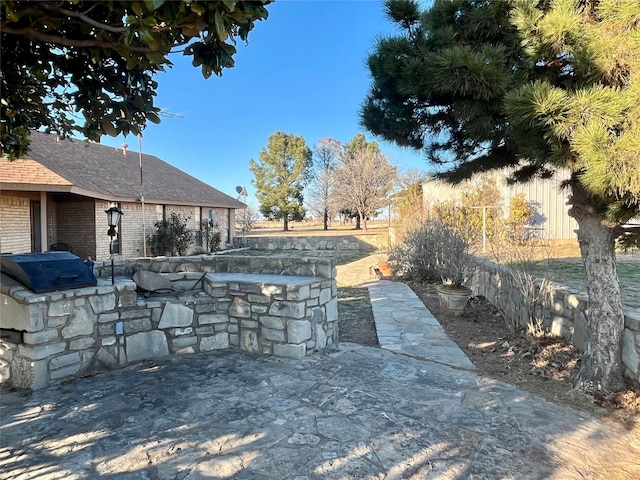 view of patio / terrace with outdoor dry bar, area for grilling, and fence