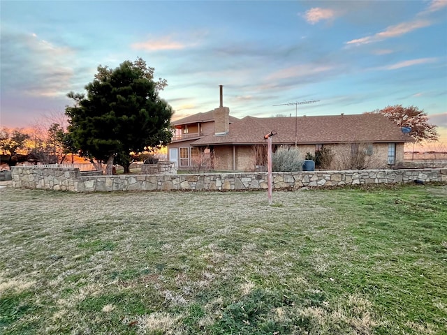 back of house with a lawn